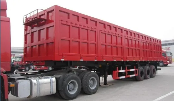 Front view of the trailer showing the side dump gate and hydraulic cylinder