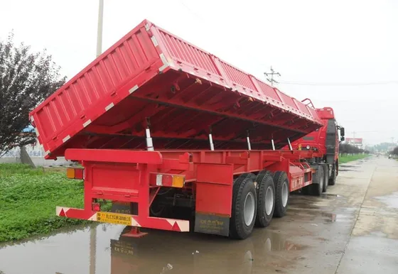 Trailer parked on a yard with the hydraulic cylinder extended and gate open