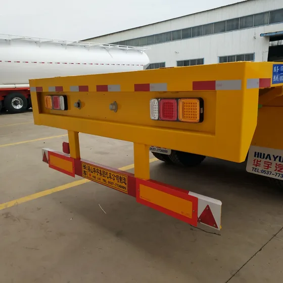 Top-down view of the flatbed floor with checkered steel plate and container securing points