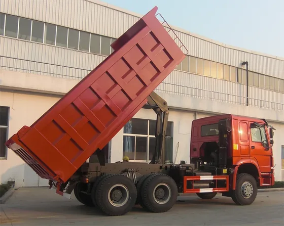 Rear view with the hydraulic dump body raised and fifth wheel coupling visible