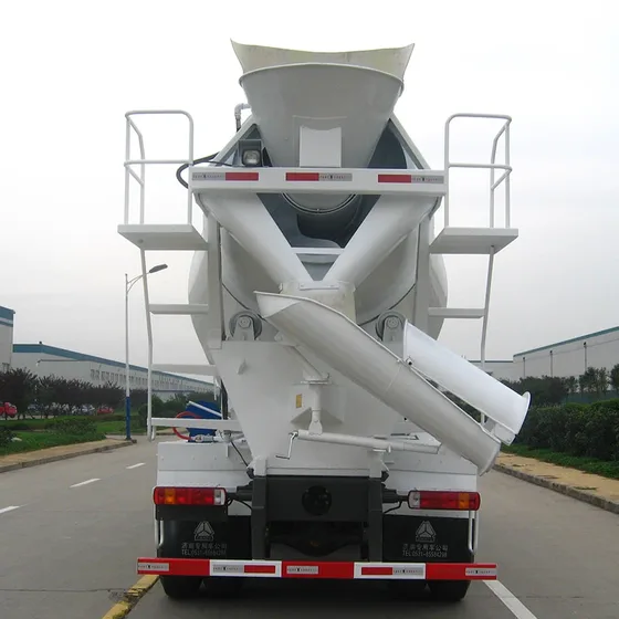 Rear view of the mixer truck with drum discharge port and air brake lines