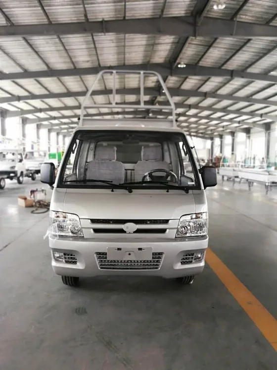 Front three-quarter view of a white Mini Electric Truck with headlight and 145/70R12 tyres