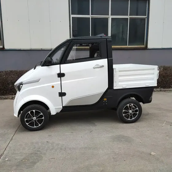 Front three-quarter view of a white EEC L6e approved electric van with closed body and middle steering