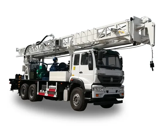 Red and white water well drilling rig on a truck chassis, side view