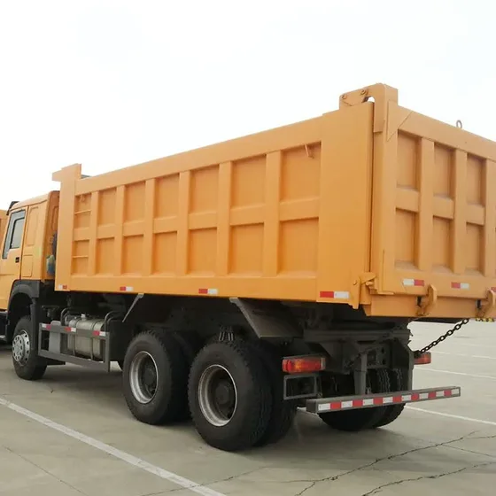 Rear view with the cargo box raised and mud flaps visible