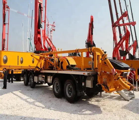 Rear view of the pump truck with outrigger legs deployed and hydraulic cylinders visible
