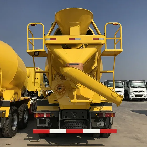 Mixer drum in operation with concrete being discharged at a construction site