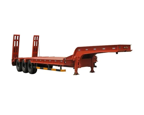 Trailer deck with a large industrial machine being loaded onto the low bed