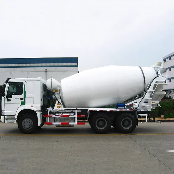 White ZZ1257N3841W concrete mixer truck parked on a yard, front three-quarter view