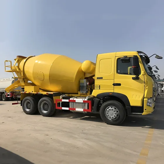White Sinotruck ZZ1257N3847N 6x4 concrete mixer truck parked on a yard, front three-quarter view