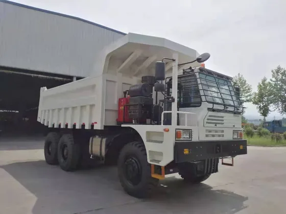 Front three-quarter view of a white HOWO 6x4 mining dump truck with 14.00-25 tyres and a single-side mine cab