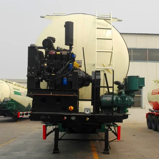 Close-up view of the rear of the cement tank trailer showing the discharge valve and manhole cover