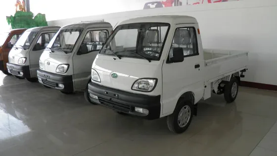 Silver GOne-T01 mini truck parked on a yard, front three-quarter view with cargo box open