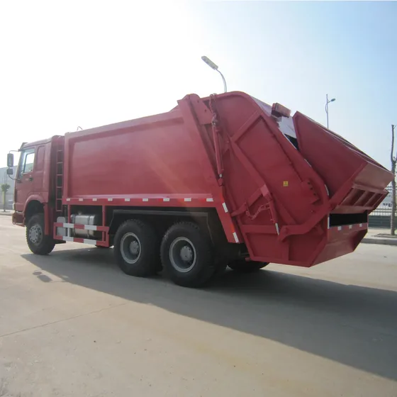 White Sinotruk HOWO street sweeper truck parked on a yard, front three-quarter view