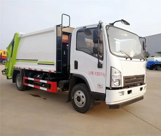 Front three-quarter view of a white HOWO 4x2 compactor garbage truck with rear flipping mechanism