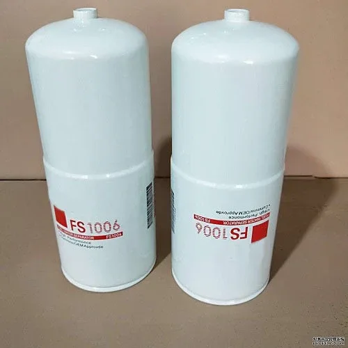 Black iron fuel water separator filter FS1006 mounted on a diesel engine fuel line, front view