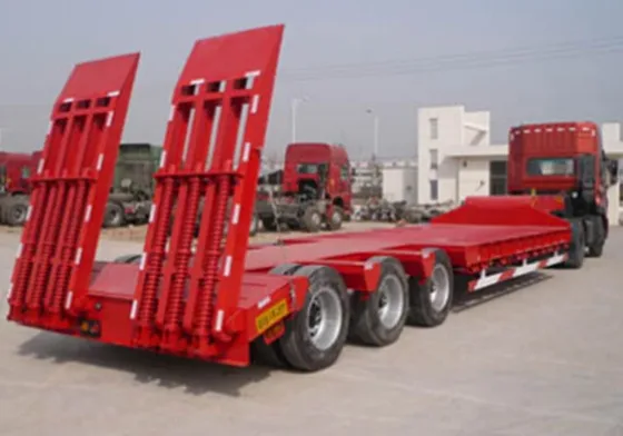 Rear view with fifth wheel coupling and mud flaps on a lowbed trailer