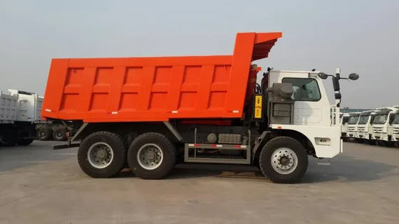 White HOWO 70T mining dump truck parked on a yard, side view