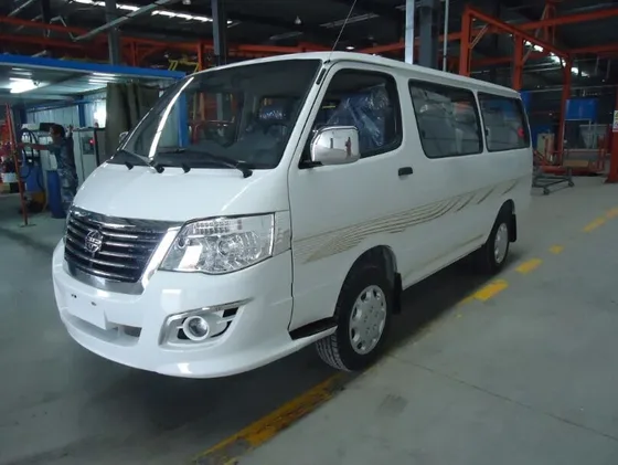 RHD 19-seat electric mini bus parked on a yard, front three-quarter view with 255/70R22.5 tyres