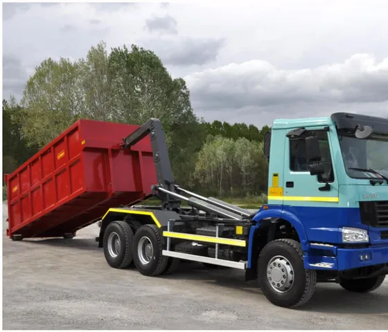 Rear view of the compactor truck with hydraulic dumping gear and sealed waste tank