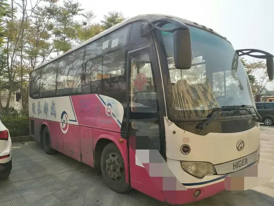12-meter luxury bus parked on a yard, front three-quarter view with air-conditioned cabin