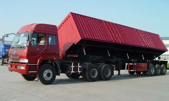 Side view of a 3-axle dump semi trailer with 1200R20 tyres and leaf spring suspension