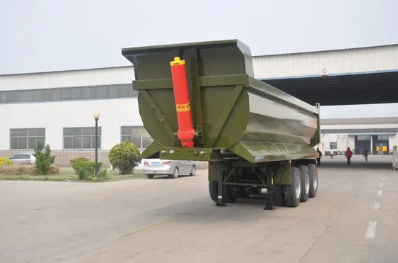 Rear view of the trailer with the side-dump gate open and rear protection panel