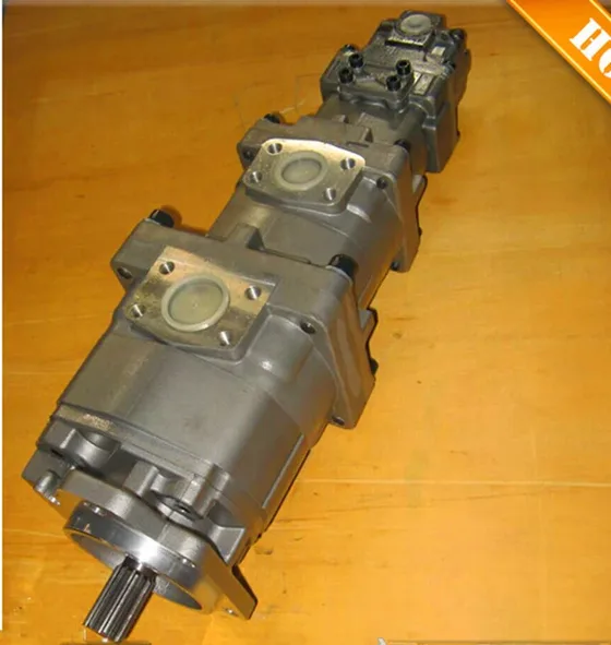 Side view of gear-type hydraulic pump showing inlet and outlet ports
