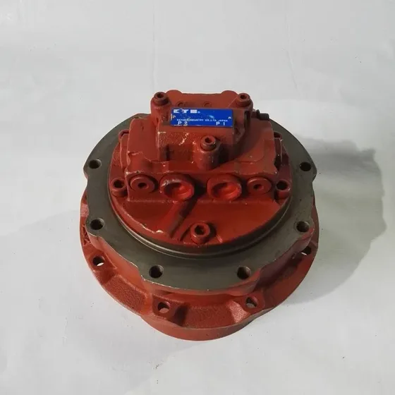 Side view of the travel motor mounted on a test bench with hydraulic hoses connected