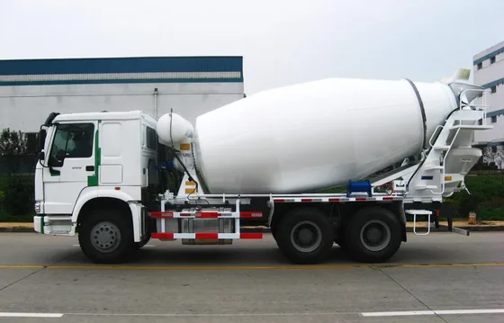 Agitator drum with mixing blades and discharge chute in open position