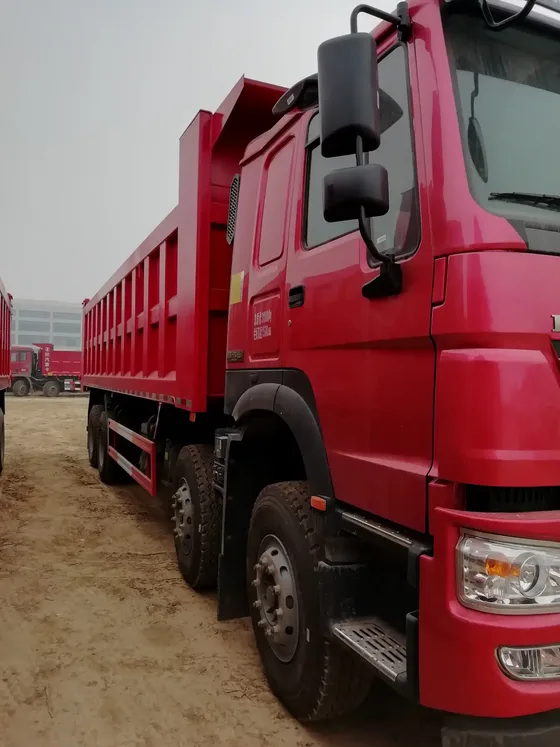 Rear view of the dump truck with hydraulic lifting cylinder and cargo box