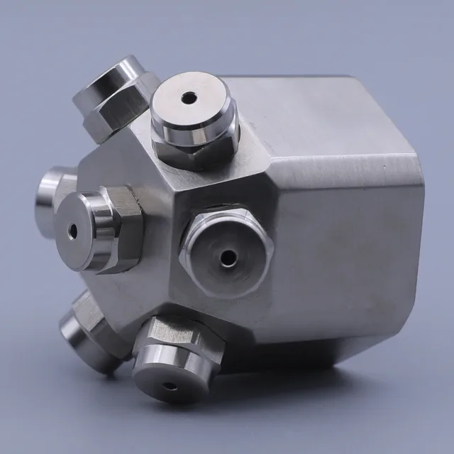 Stainless steel multi-port manifold block with hexagonal fittings on a solid background