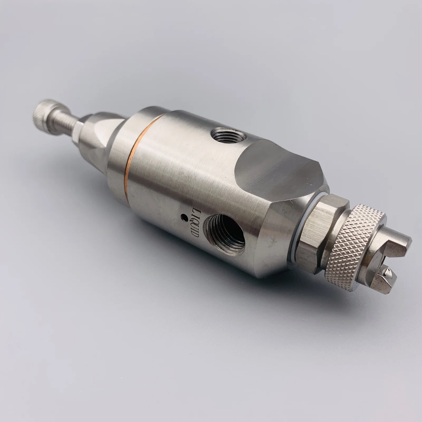 A stainless steel industrial valve component with threaded ports and knurled adjustment nuts