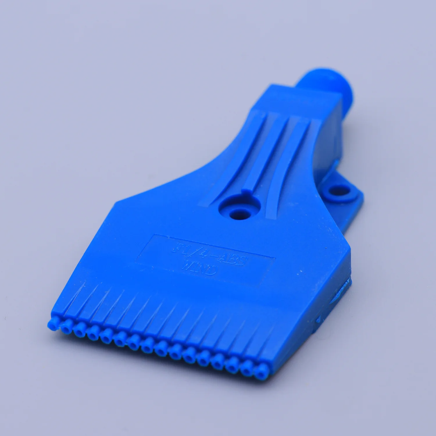 Blue plastic industrial tool with a row of small nozzles on a plain background