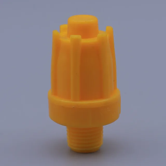 Yellow plastic nozzle with a threaded base and vertical fins on a gray background