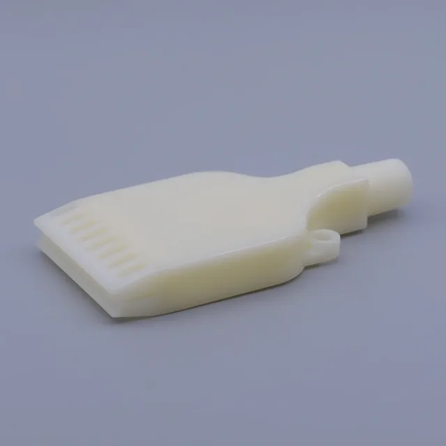 A close-up of a custom-molded, off-white plastic component with a nozzle and a flat, ribbed head