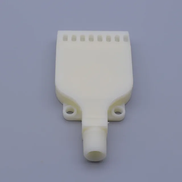 White plastic spray manifold with row of nozzles and central inlet