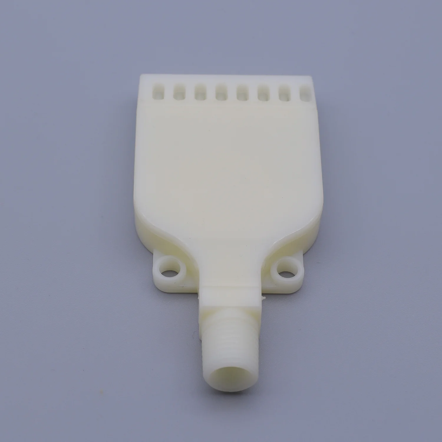 White plastic spray manifold with row of nozzles and central inlet