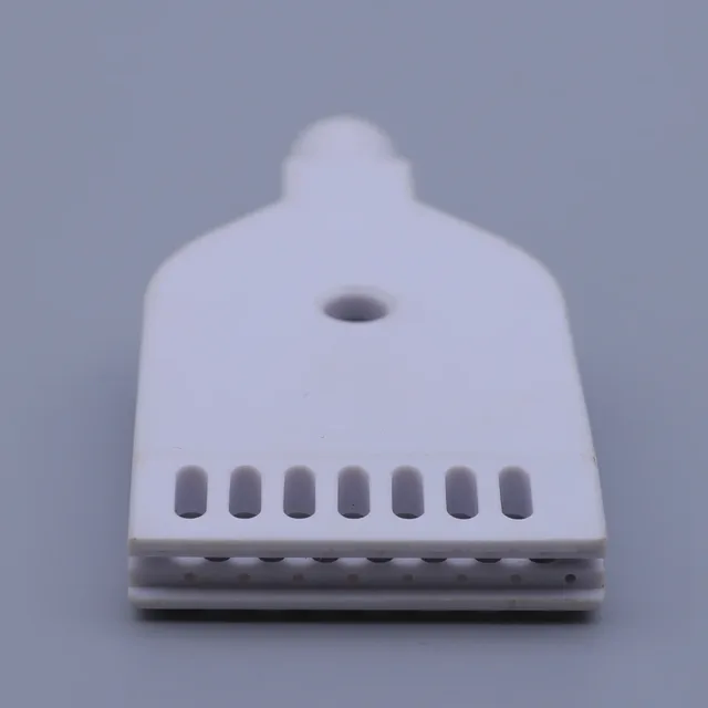 White plastic component with a mounting hole and a row of eight vertical slots on a gray background