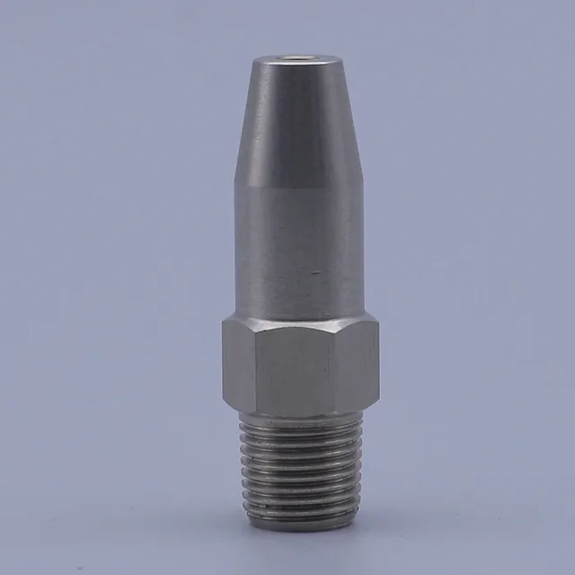 Stainless steel conical nozzle with hex nut base and male threads on gray background