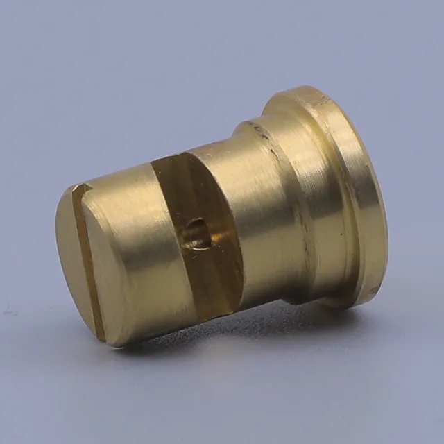 Machined brass bushing with a flanged end and side slot on a gray background