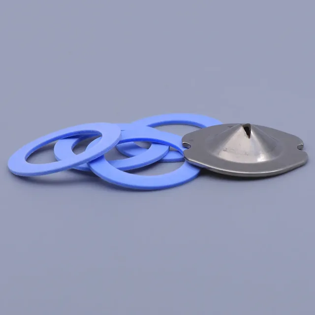 A pile of blue rubber gaskets and a metal center piece on a gray background