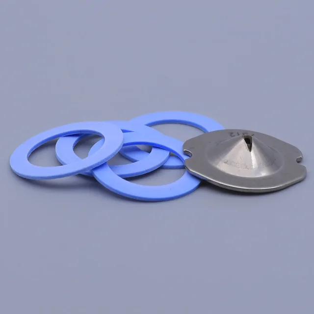 A stainless steel rupture disc and four blue silicone gaskets arranged on a grey background
