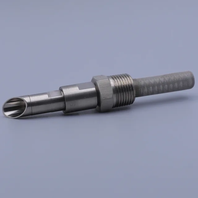 Stainless steel machined part with threaded shaft, hex nut, and slotted tip on a blue background