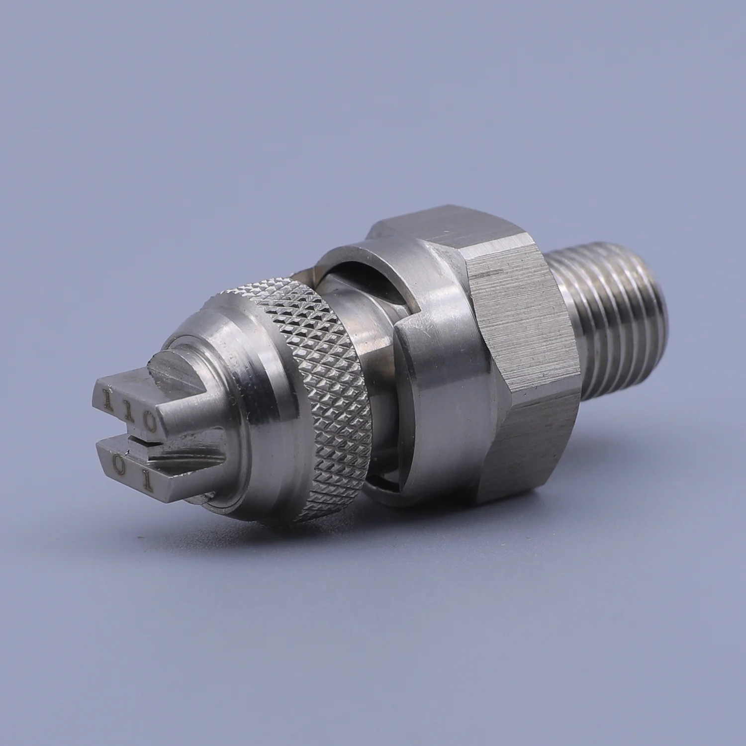 Stainless steel spray nozzle with external thread and knurled locking ring on a solid background