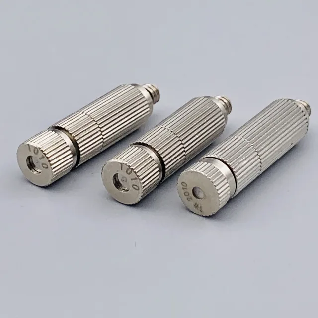 Three silver knurled cylindrical metal components with threaded connectors arranged diagonally on a gray background