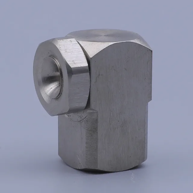 Angled view of a silver stainless steel 90-degree elbow fitting with hexagonal ends on a light blue background