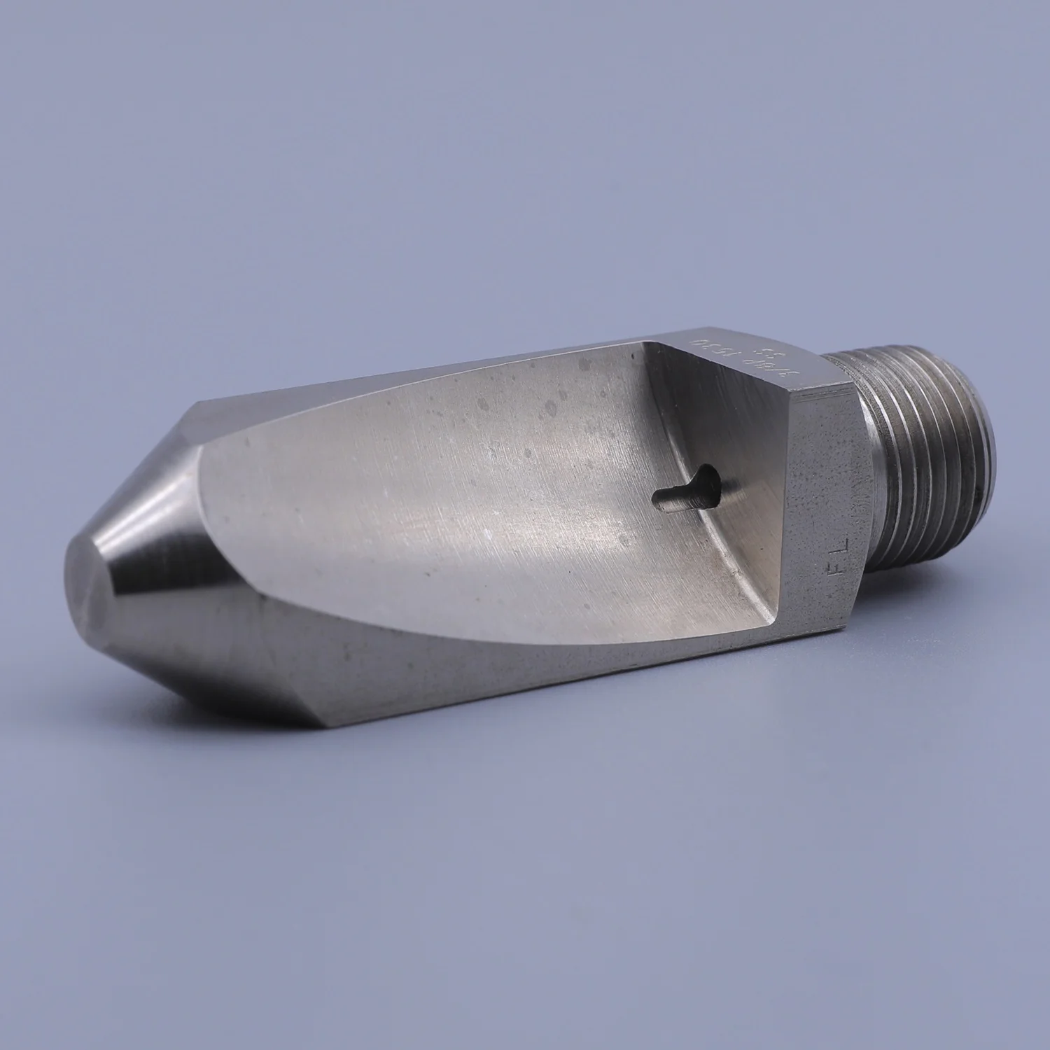 Stainless steel flat fan spray nozzle with external thread connection on a gray background