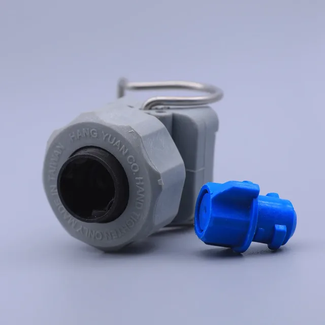 Gray plastic industrial valve lockout device with metal hasp and a blue electrical plug insert on a white background