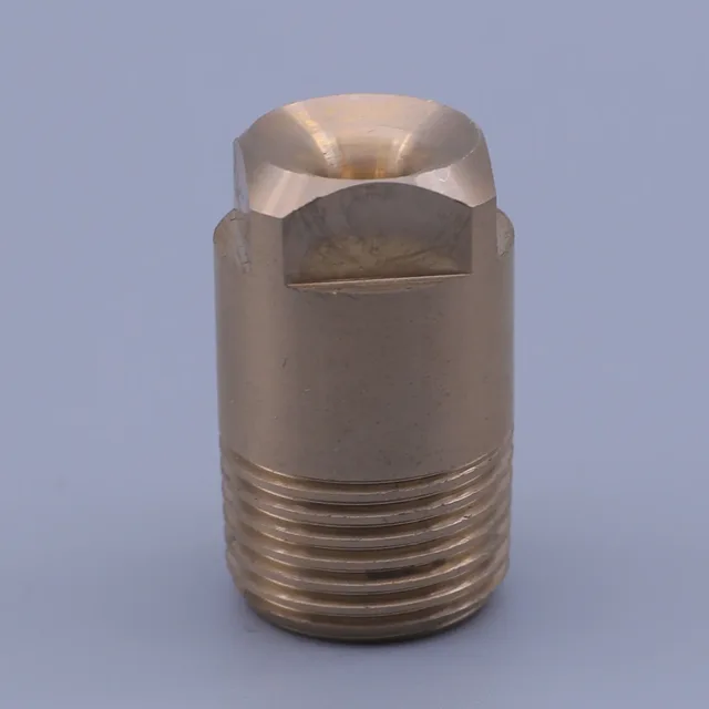 Close-up of a brass threaded fitting with a hexagonal head against a blue background